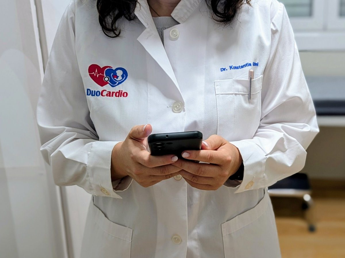 Ιατρός του DuoCardio με το κινητό τηλέφωνο στα χέρια